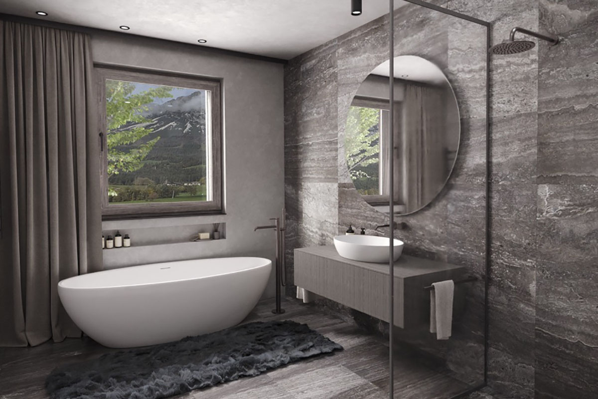 Ein modernes Badezimmer mit freistehender Badewanne, Dusche mit Regendusche, großem Spiegel und Aussicht auf grüne Berge.