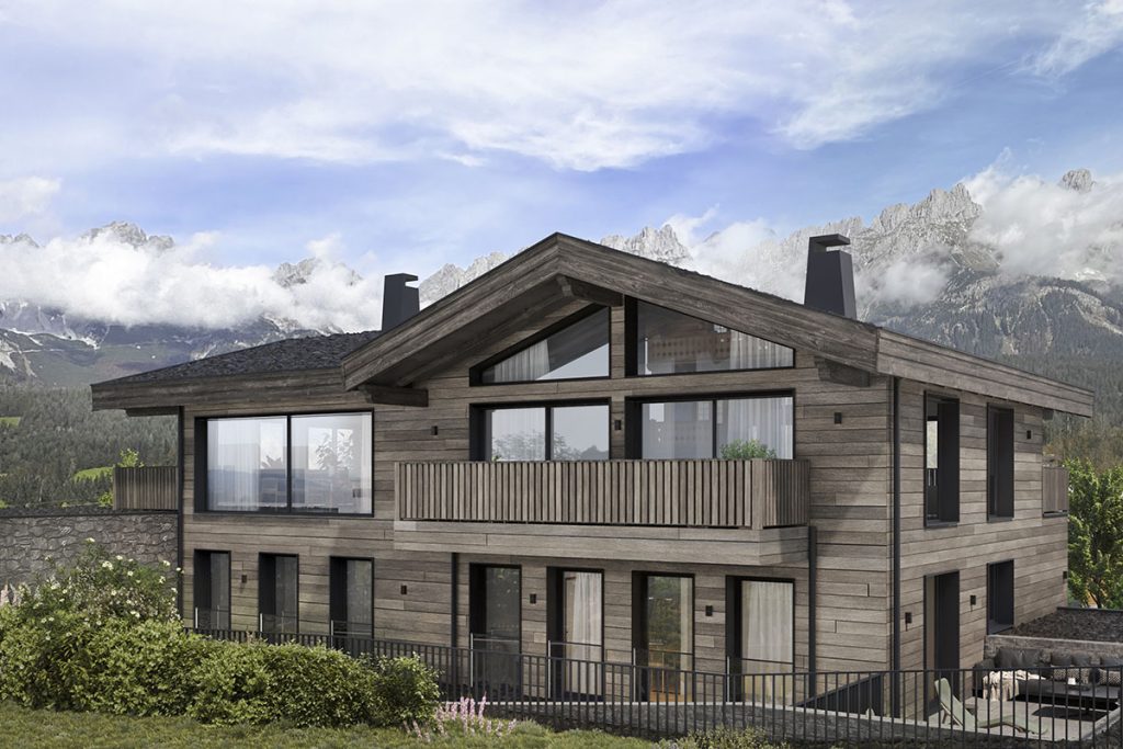 Modernes Chalet mit Holzfassade und großen Fenstern, umgeben von majestätischen Bergen und Wolken, idyllisch gelegen.